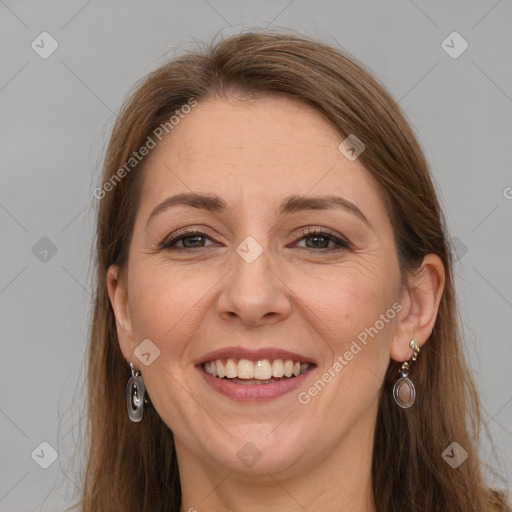 Joyful white adult female with long  brown hair and grey eyes