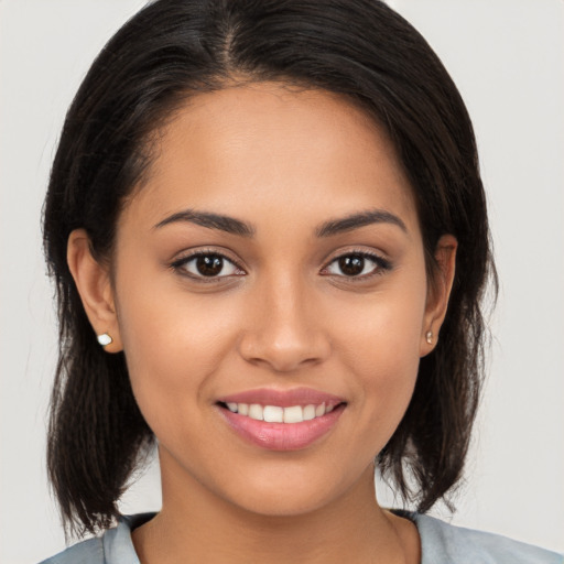 Joyful white young-adult female with medium  brown hair and brown eyes