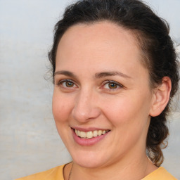 Joyful white adult female with medium  brown hair and brown eyes