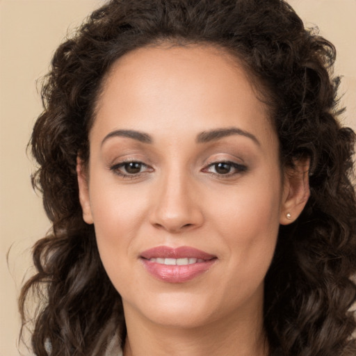 Joyful white young-adult female with long  brown hair and brown eyes