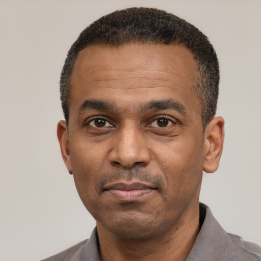 Neutral latino adult male with short  black hair and brown eyes