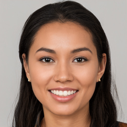 Joyful white young-adult female with long  black hair and brown eyes