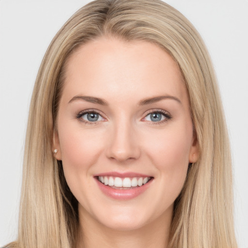 Joyful white young-adult female with long  brown hair and blue eyes