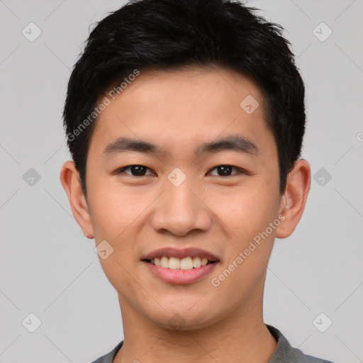 Joyful asian young-adult male with short  black hair and brown eyes