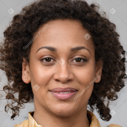 Joyful black adult female with medium  brown hair and brown eyes