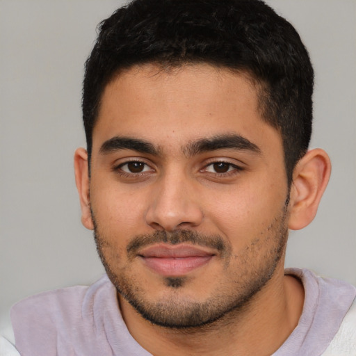 Joyful latino young-adult male with short  brown hair and brown eyes