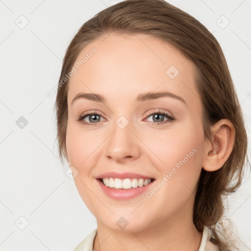 Joyful white young-adult female with medium  brown hair and green eyes