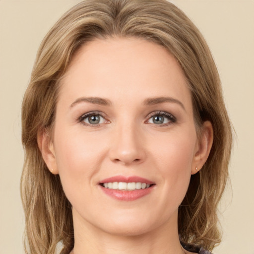 Joyful white young-adult female with long  brown hair and green eyes