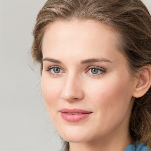 Joyful white young-adult female with medium  brown hair and blue eyes