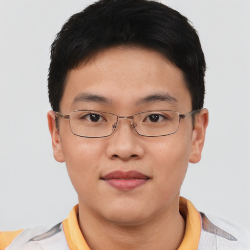 Joyful asian young-adult male with short  brown hair and brown eyes