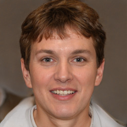 Joyful white adult male with short  brown hair and brown eyes