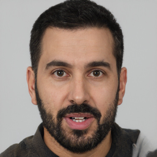 Joyful white young-adult male with short  black hair and brown eyes