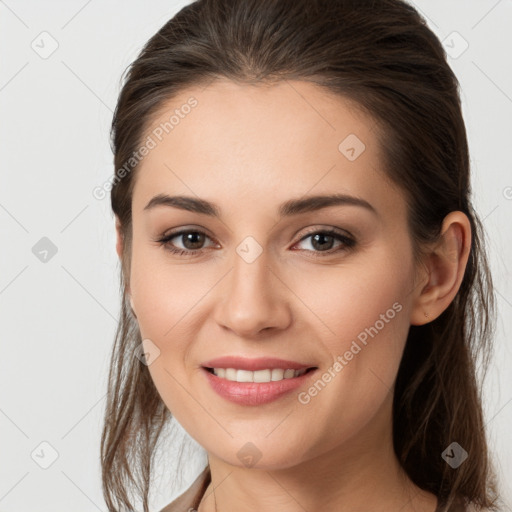 Joyful white young-adult female with long  brown hair and grey eyes