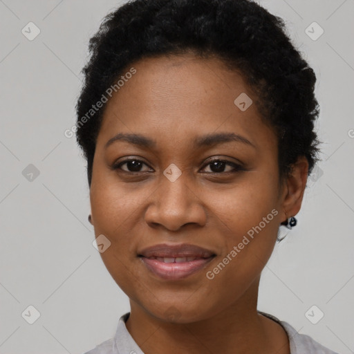 Joyful black young-adult female with short  black hair and brown eyes