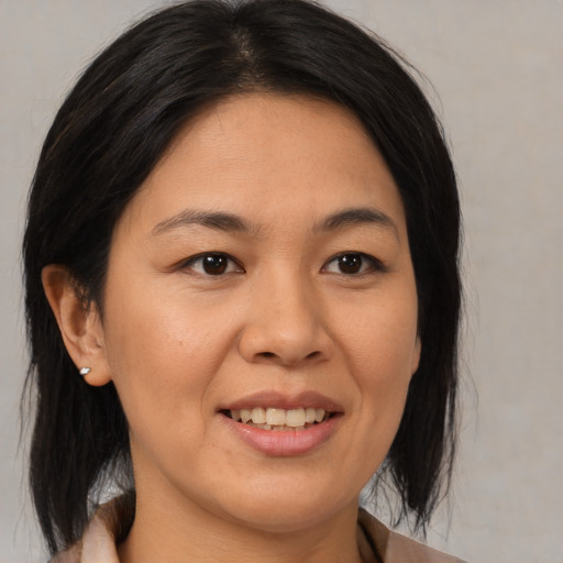 Joyful asian young-adult female with medium  brown hair and brown eyes