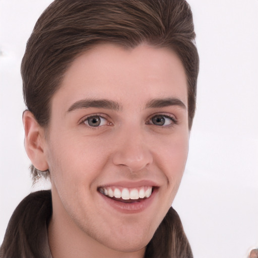 Joyful white young-adult male with long  brown hair and grey eyes