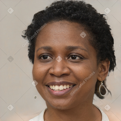 Joyful black young-adult female with short  brown hair and brown eyes