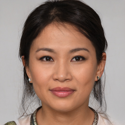 Joyful asian young-adult female with medium  brown hair and brown eyes