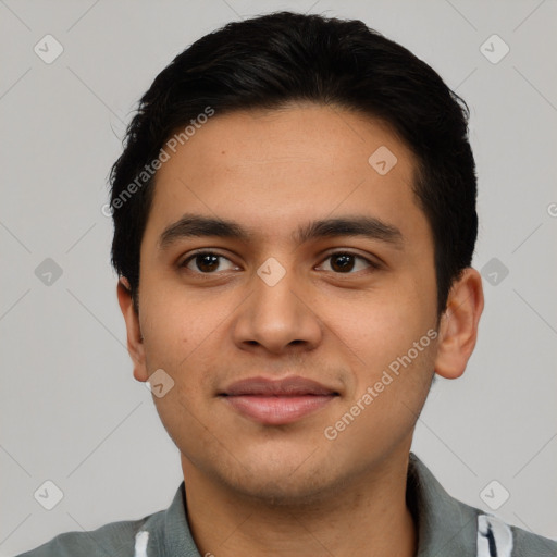 Joyful latino young-adult male with short  black hair and brown eyes