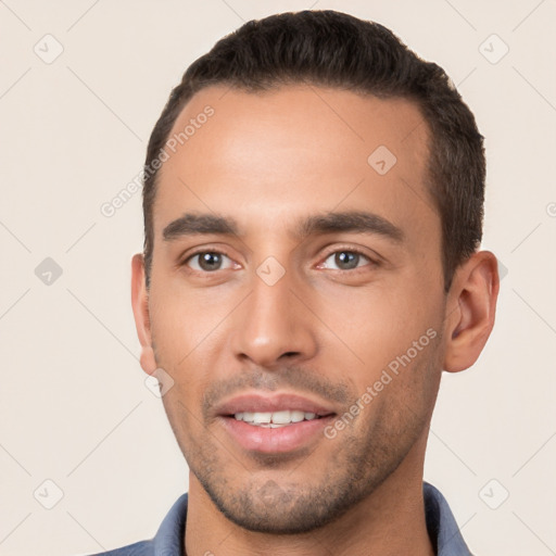 Joyful white young-adult male with short  brown hair and brown eyes