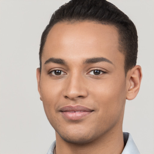 Joyful latino young-adult male with short  brown hair and brown eyes