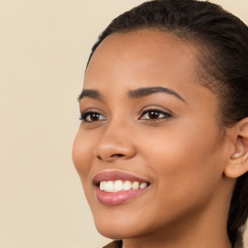 Joyful latino young-adult female with long  brown hair and brown eyes