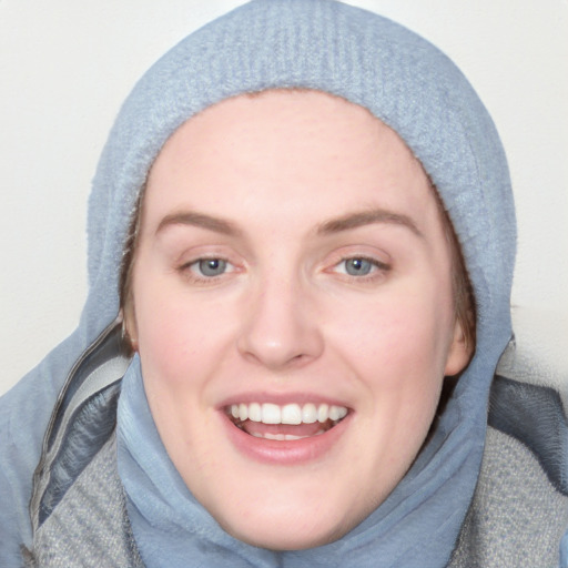 Joyful white young-adult female with long  brown hair and blue eyes