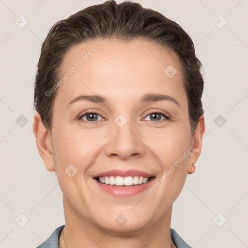 Joyful white young-adult female with short  brown hair and grey eyes