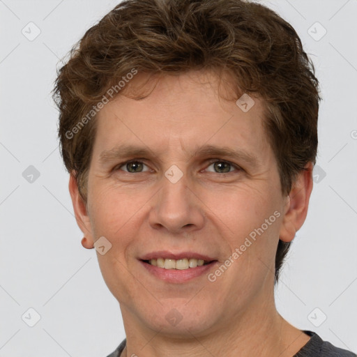 Joyful white adult male with short  brown hair and grey eyes