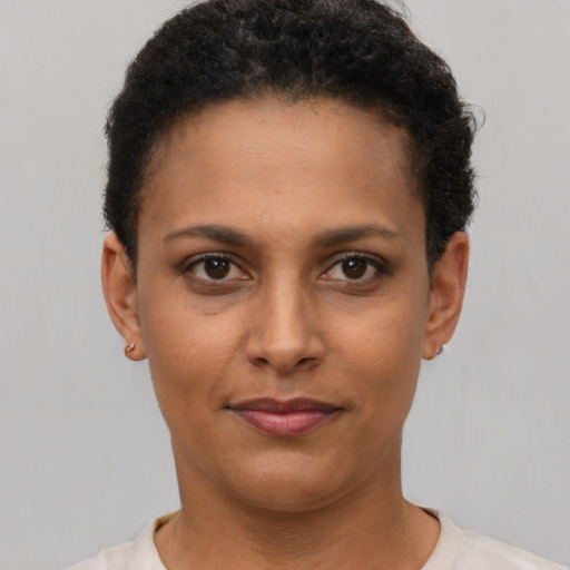 Joyful latino young-adult female with short  brown hair and brown eyes