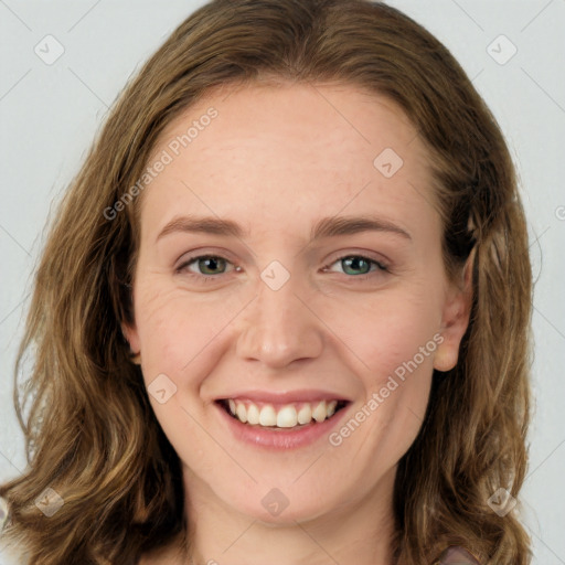 Joyful white young-adult female with long  brown hair and green eyes