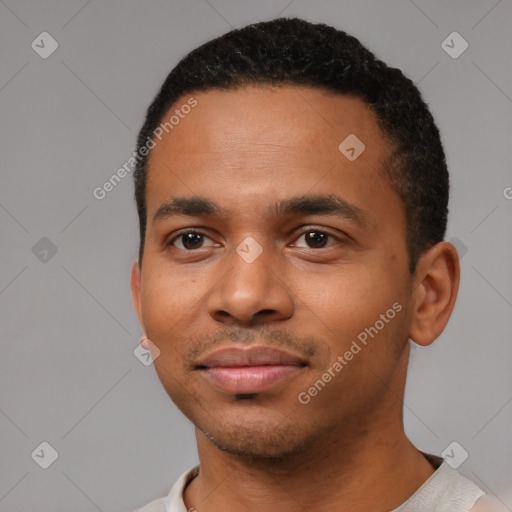 Joyful black young-adult male with short  black hair and brown eyes