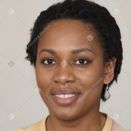 Joyful black young-adult female with short  brown hair and brown eyes