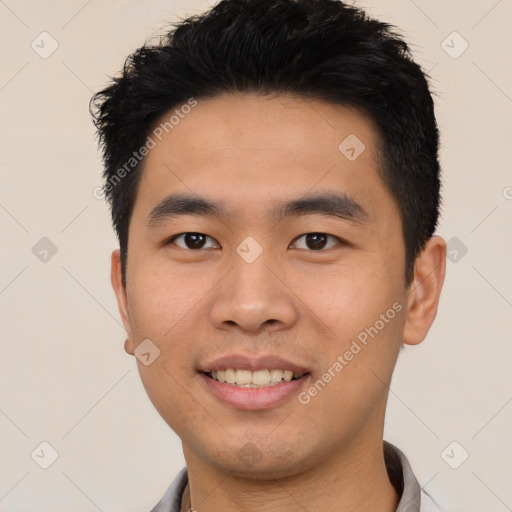 Joyful asian young-adult male with short  black hair and brown eyes