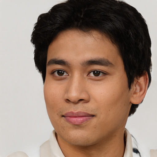 Joyful latino young-adult male with short  brown hair and brown eyes