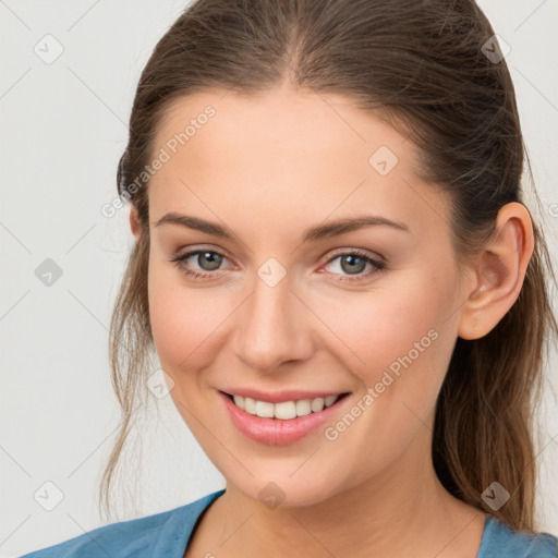 Joyful white young-adult female with medium  brown hair and grey eyes