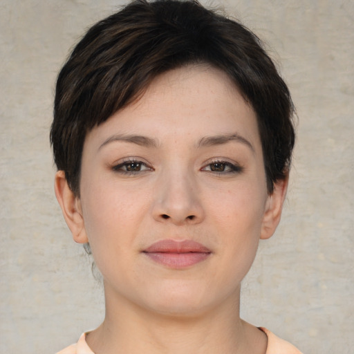 Joyful asian young-adult female with short  brown hair and brown eyes