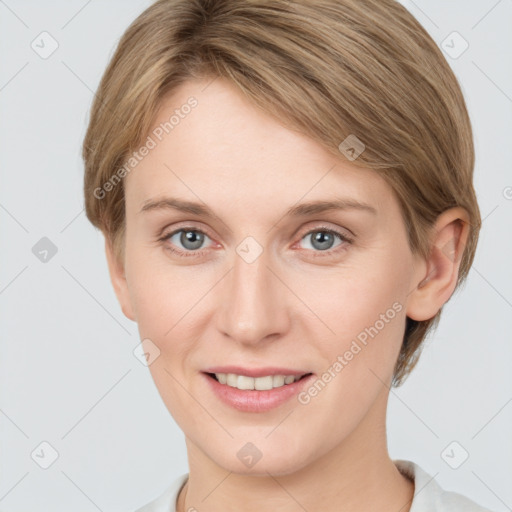 Joyful white young-adult female with short  brown hair and grey eyes