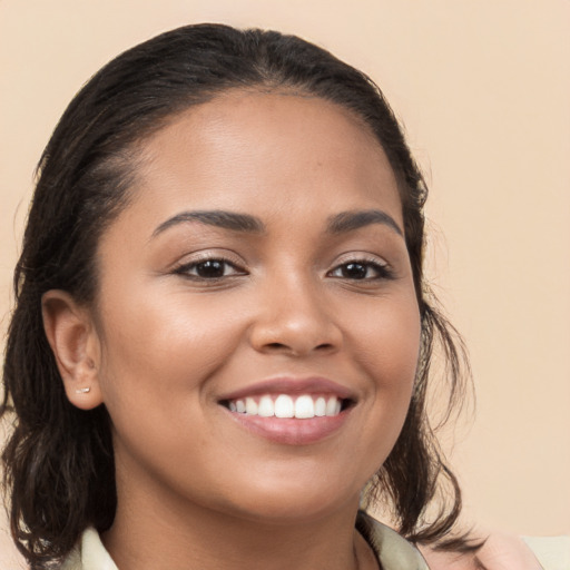 Joyful latino young-adult female with medium  brown hair and brown eyes