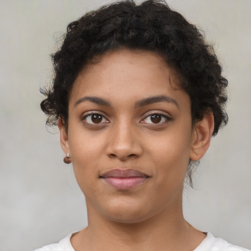 Joyful latino young-adult female with short  brown hair and brown eyes