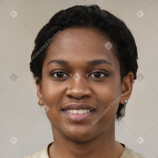 Joyful black young-adult female with short  black hair and brown eyes