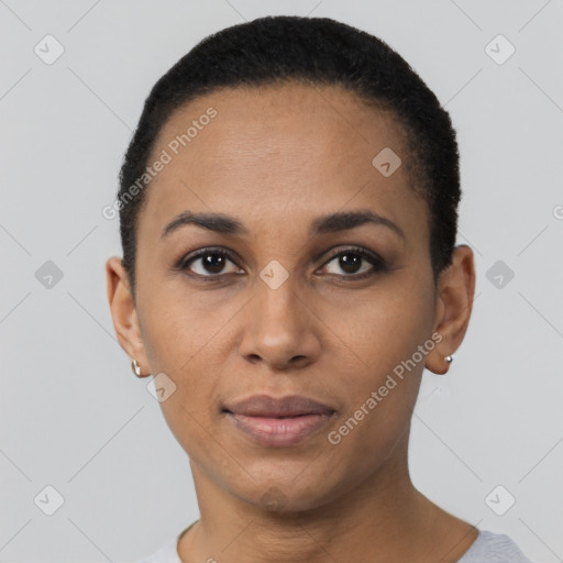 Joyful black young-adult female with short  black hair and brown eyes