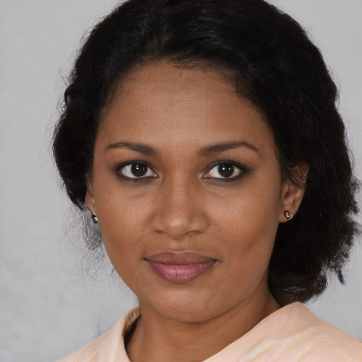 Joyful black young-adult female with medium  brown hair and brown eyes