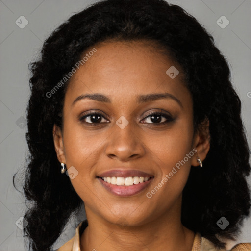 Joyful black young-adult female with long  black hair and brown eyes