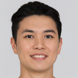 Joyful asian young-adult male with short  brown hair and brown eyes