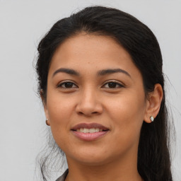 Joyful latino young-adult female with long  brown hair and brown eyes