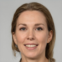 Joyful white adult female with medium  brown hair and grey eyes