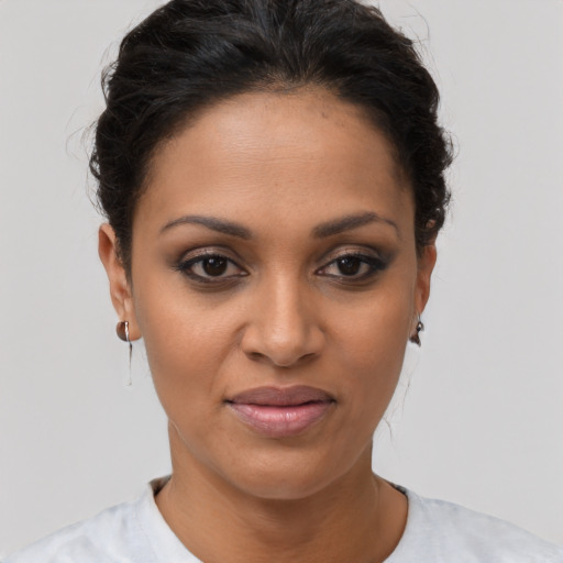 Joyful latino young-adult female with short  brown hair and brown eyes