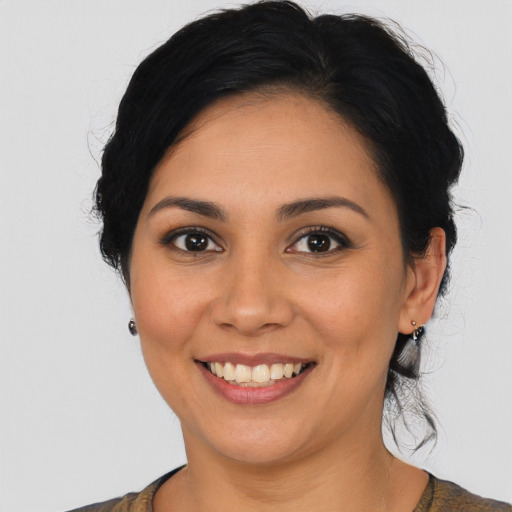 Joyful latino young-adult female with medium  black hair and brown eyes