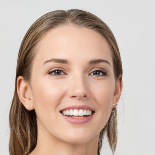 Joyful white young-adult female with long  brown hair and grey eyes